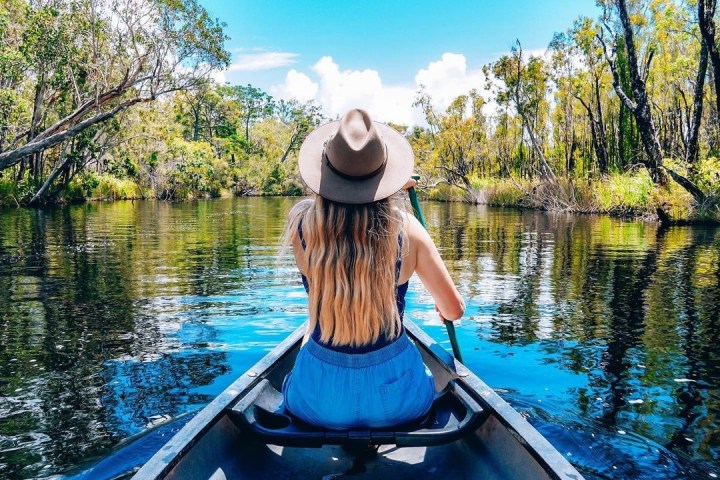 a person standing next to a body of water