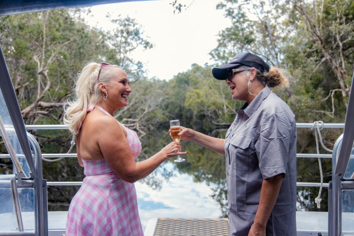 a man standing next to a fence