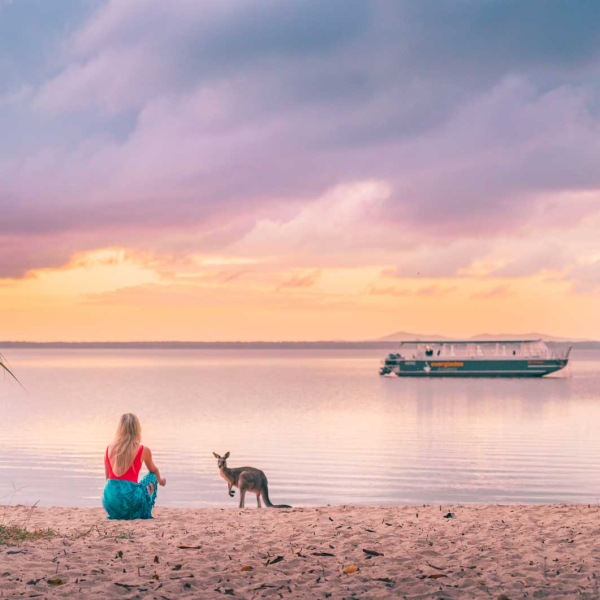 a group of people on a beach near a body of water
