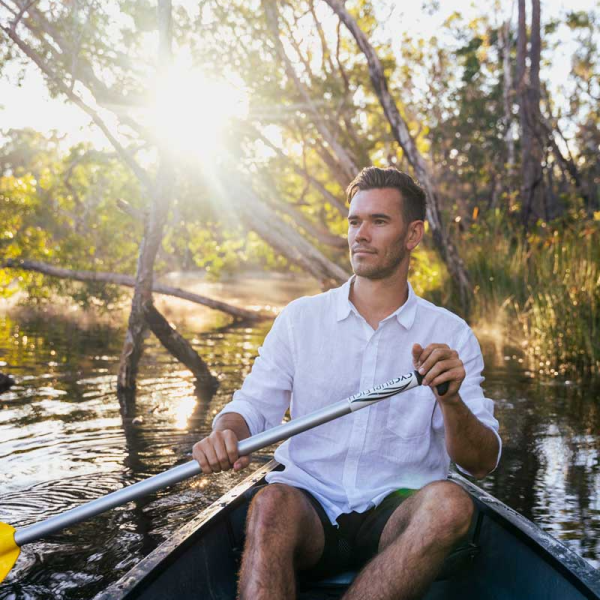 a man sitting on a boat in the water
