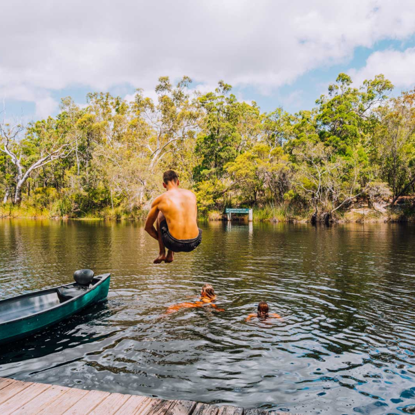 a person riding on the back of a boat in the water