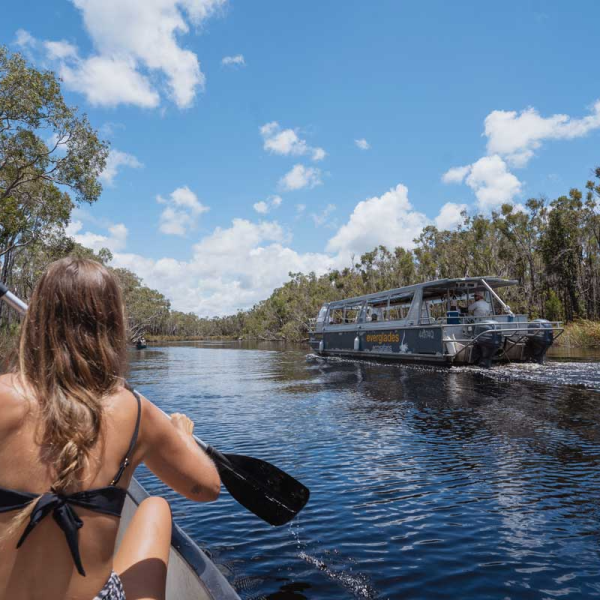 a woman standing next to a body of water
